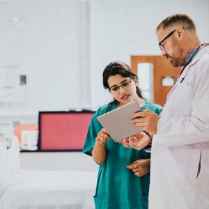 A doctor and nurse communicating a patience chart