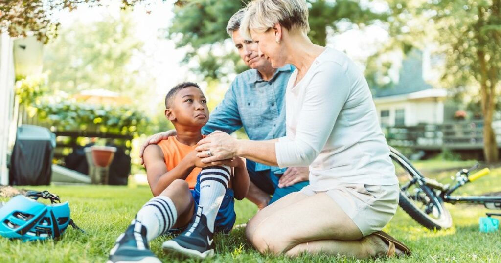 A nurse helping an injured boy